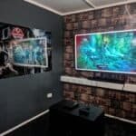 Two large screens displaying immersive video game scenes at Arcade Time Machine.