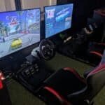 Racing game setup with two screens and racing seats at Arcade Time Machine.