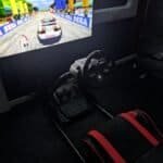 Racing arcade game with steering wheel and pedal at Arcade Time Machine.